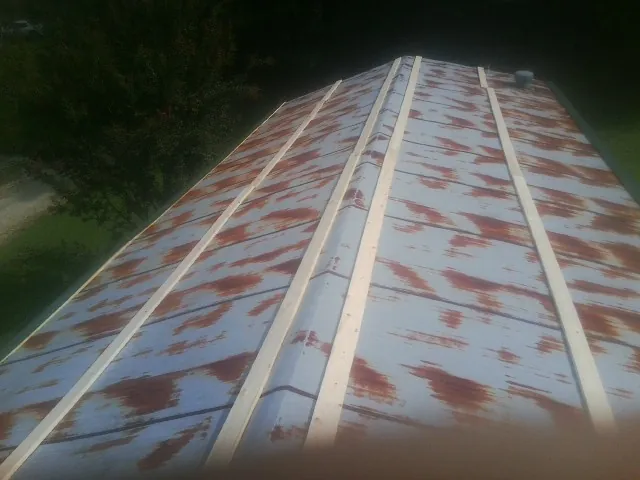Rusted metal roof panels with new wood purlins before replacement — Storm Damage Roof Repair in Scotia by Roofing Brothers