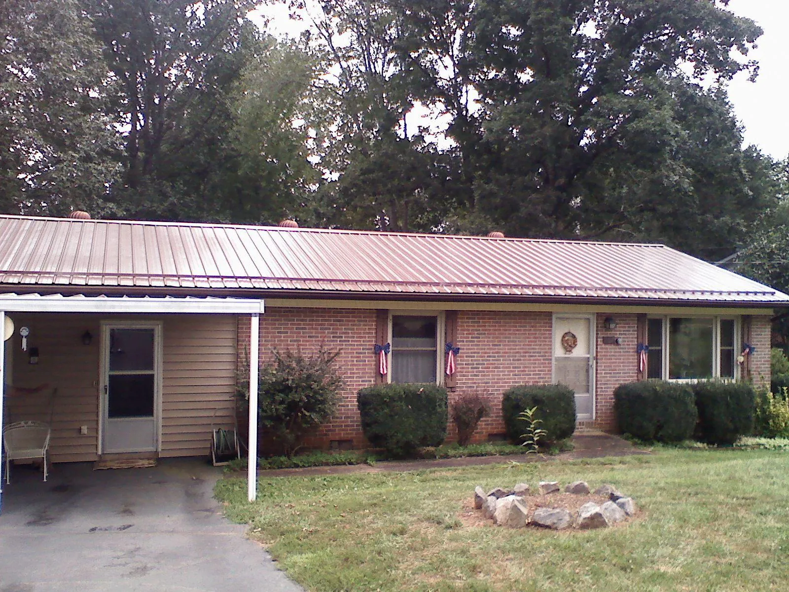 Bronze metal roof and carport on a brick ranch home — Roof Repair work by our crew in Scotia